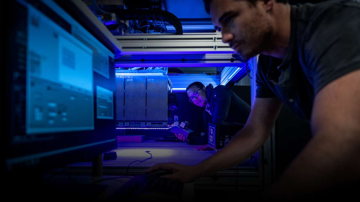 Aerospace scientists operate the solar simulator to test solar cells in the laboratory.