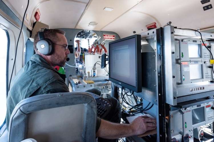Scientist checking data from imaging from plane